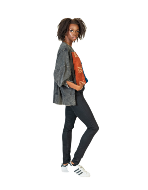 A woman standing with her hands in her pockets